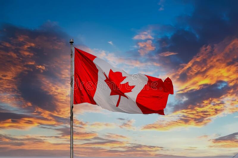 canadian-flag-flying-sunset-red-white-179716462.jpg